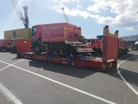 Camion de pompiers arrimé et sanglé sur un conteneur plateau au port — IFTL